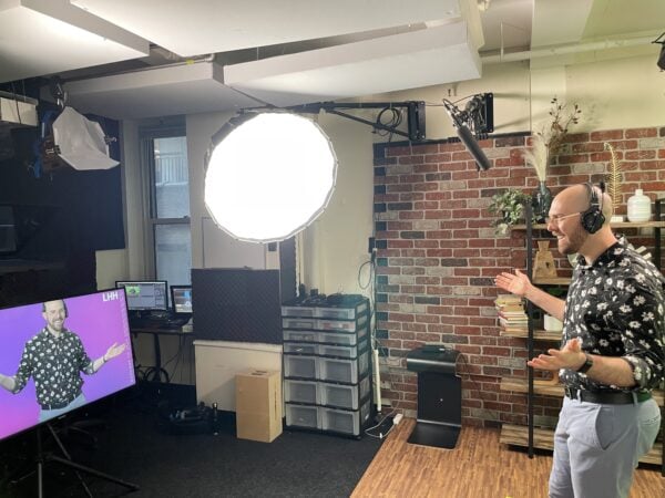 man on video set looking into monitor